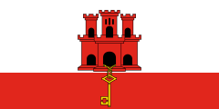 white with a red castle in the middle and a red stripe along the bottom with a yellow key
