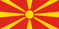 red with a yellow 8-ray sunburst extending to all the edges of the flag