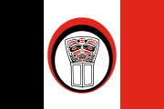 red-white-black bands with a thick middle stripe and a copper shield within a red-black circle